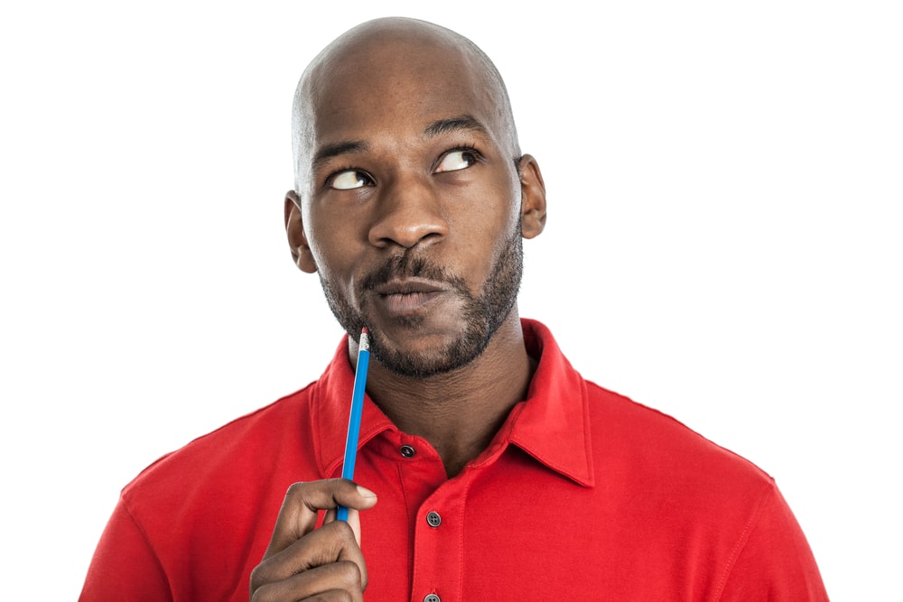 black man in thought about scalp micropigmentation