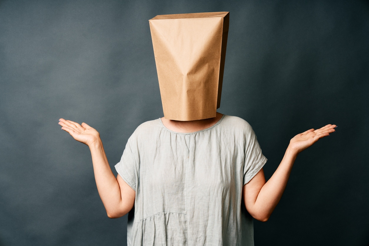 Woman with paper bag on her head.